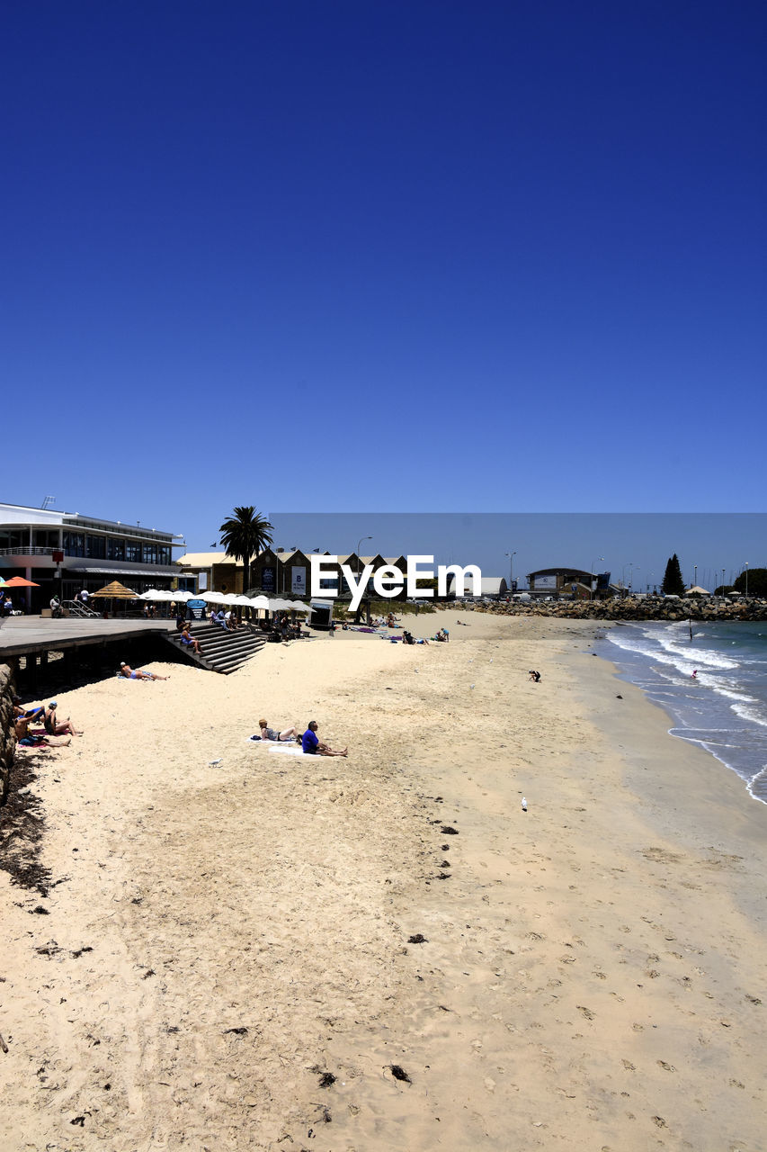 BEACH BY SEA AGAINST CLEAR BLUE SKY