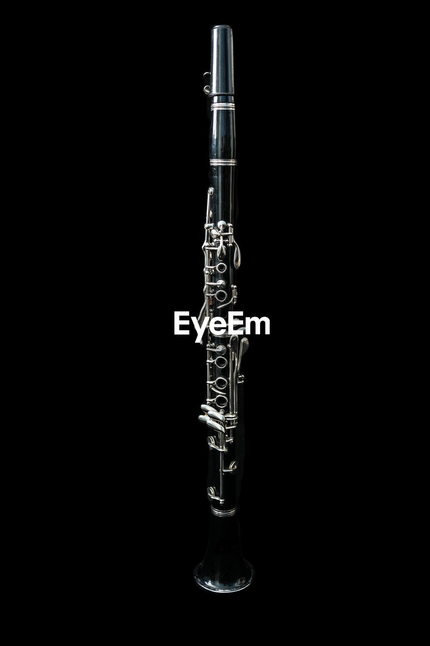 Close-up of flute against black background