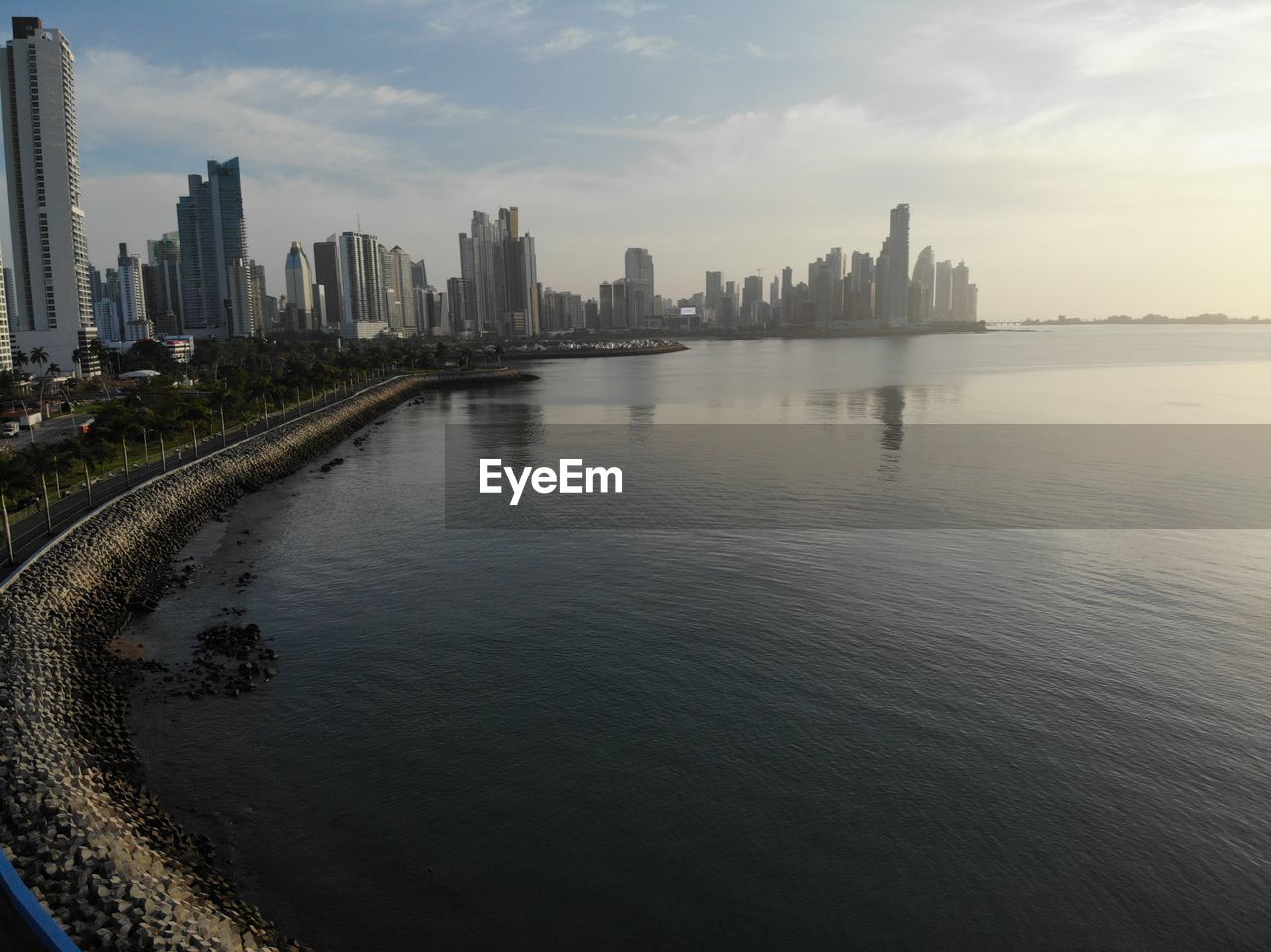 Scenic view of river by buildings against sky in city