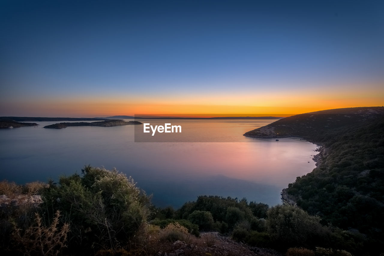 Scenic view of sea against clear sky during sunset