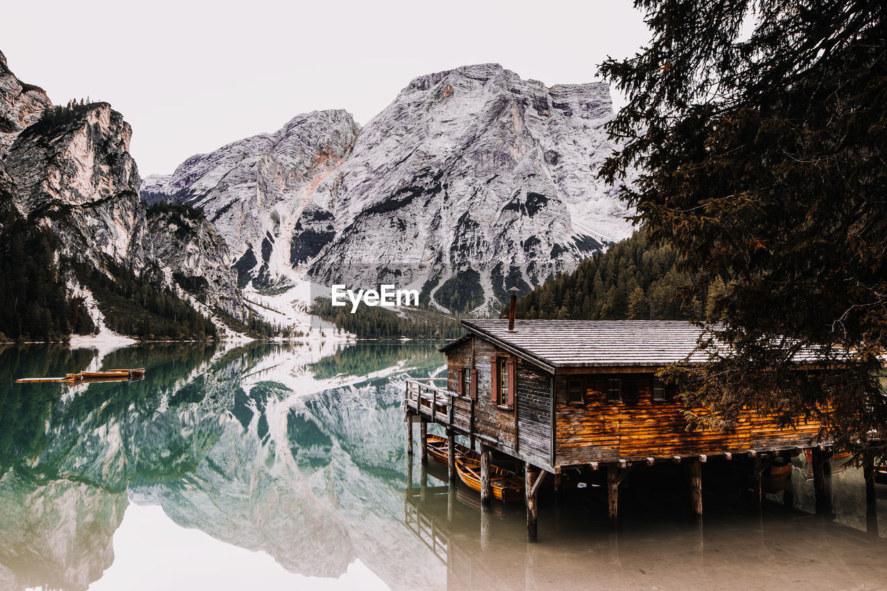 High angle view of stilt house in lake by mountains