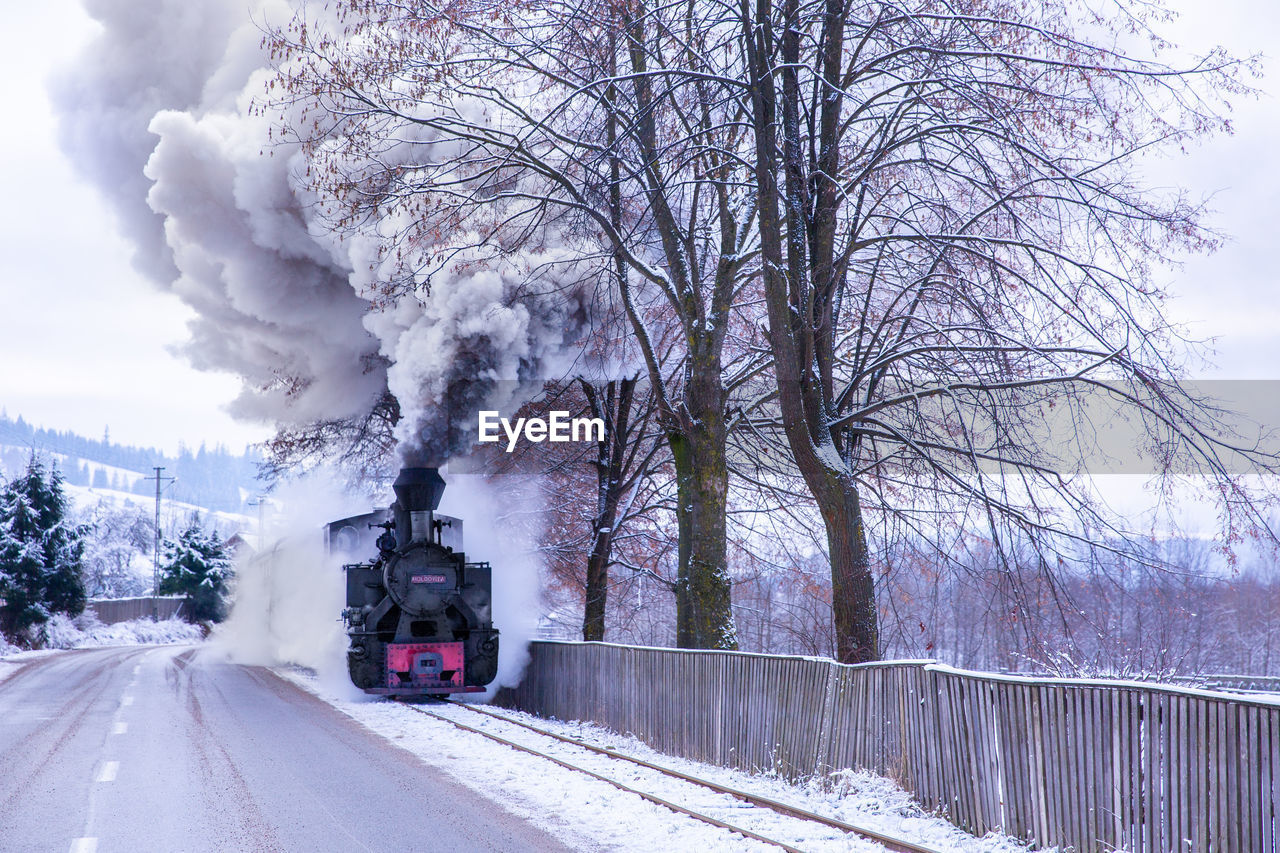 Steam train on a snow covered railtrack