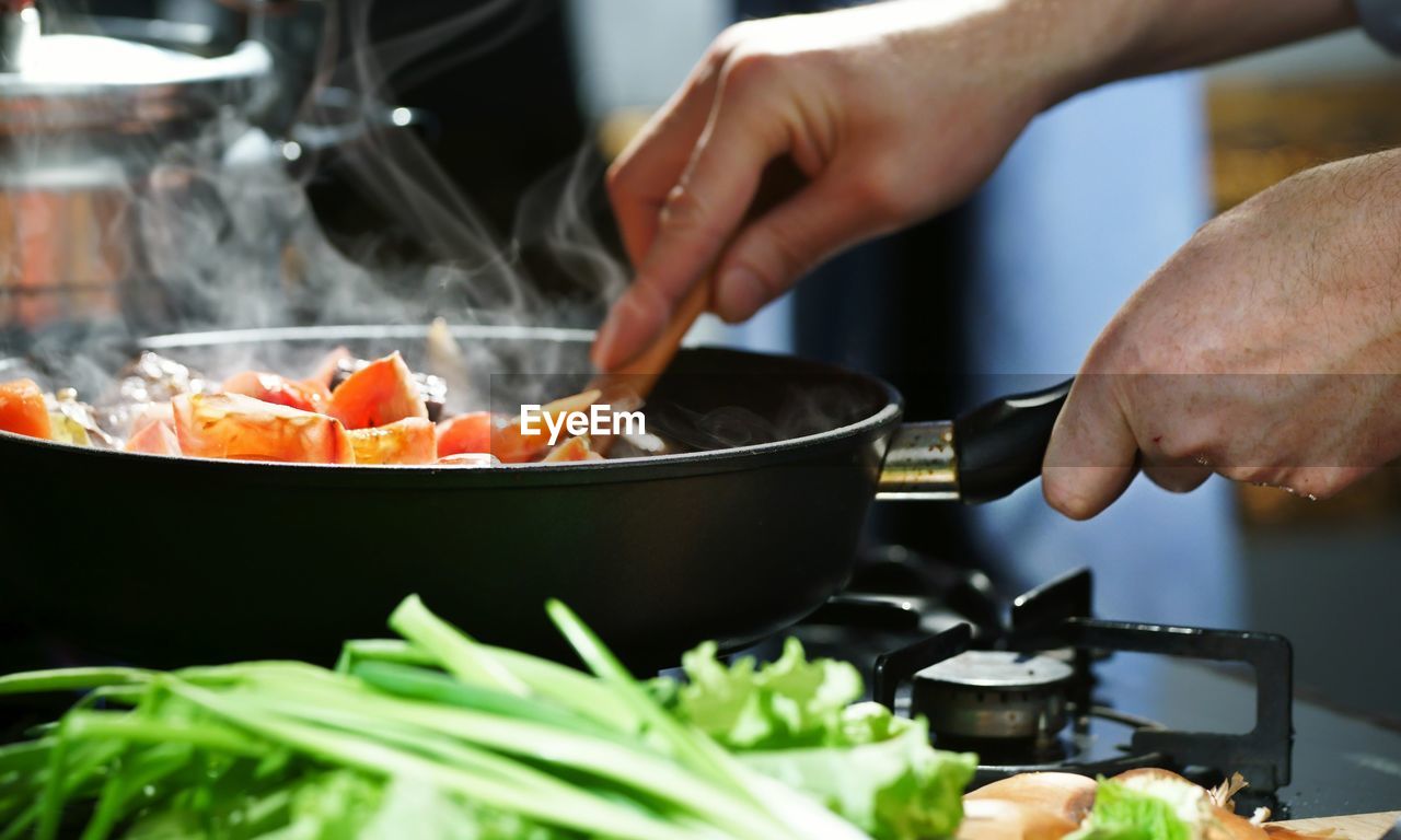 cropped hand preparing food