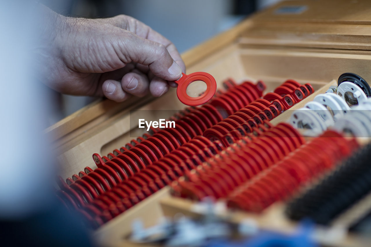 Optometrist choosing eye test lenses, close up