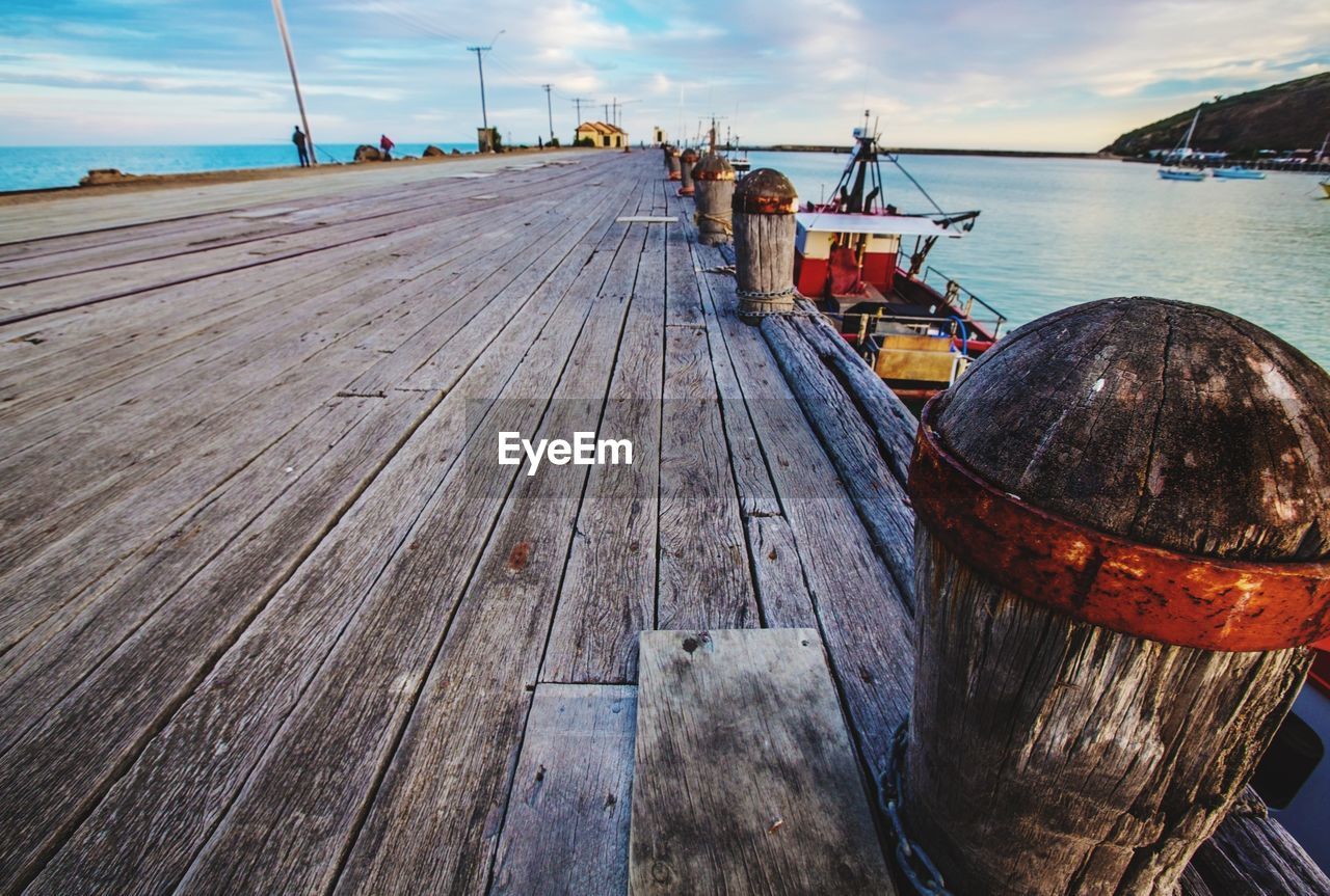 BOATS MOORED AT PIER