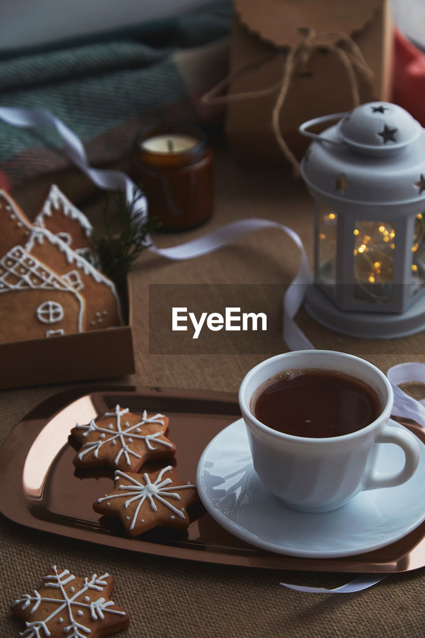 Aesthetics christmas mood with gingerbread cookies, cocoa, light, candles background.