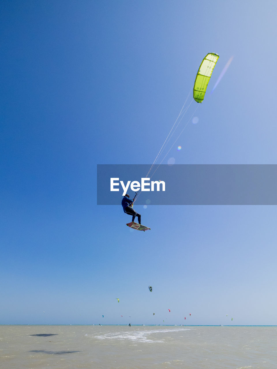Low angle view of man kitesurfing in mid-air