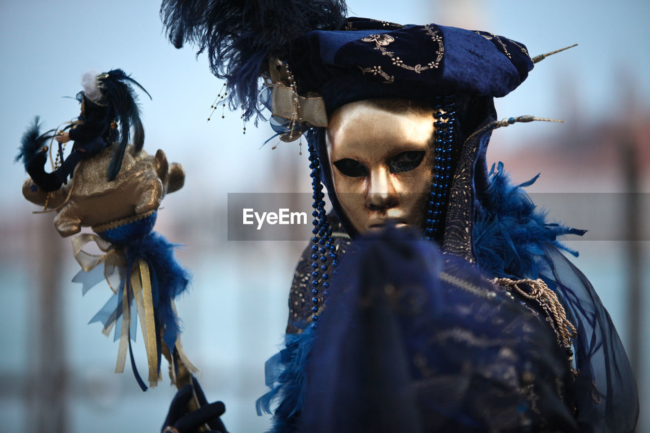 Portrait of person wearing venetian mask 