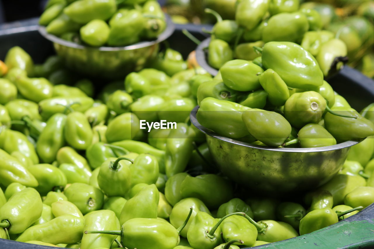 CLOSE-UP OF GREEN CHILI PEPPERS IN MARKET