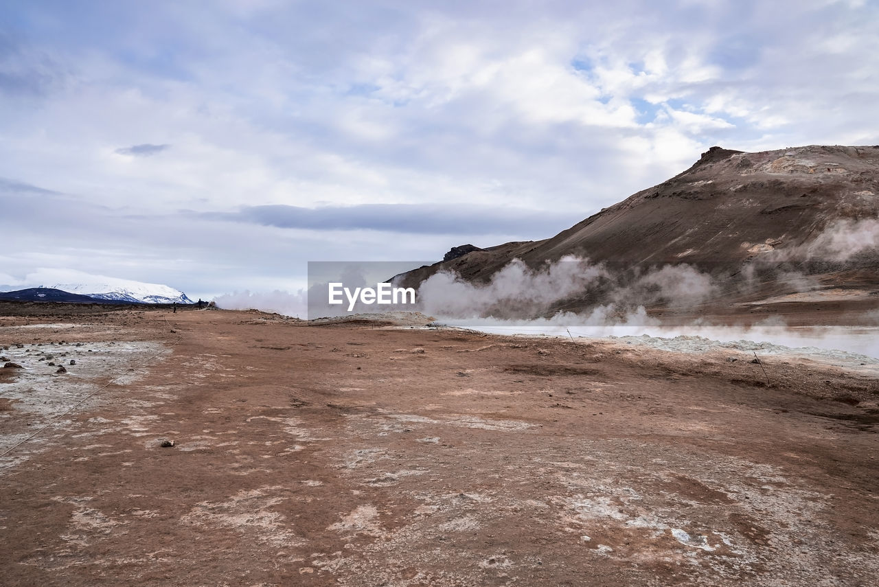 View of steam emitting from volcanic crater in geothermal area of hverir