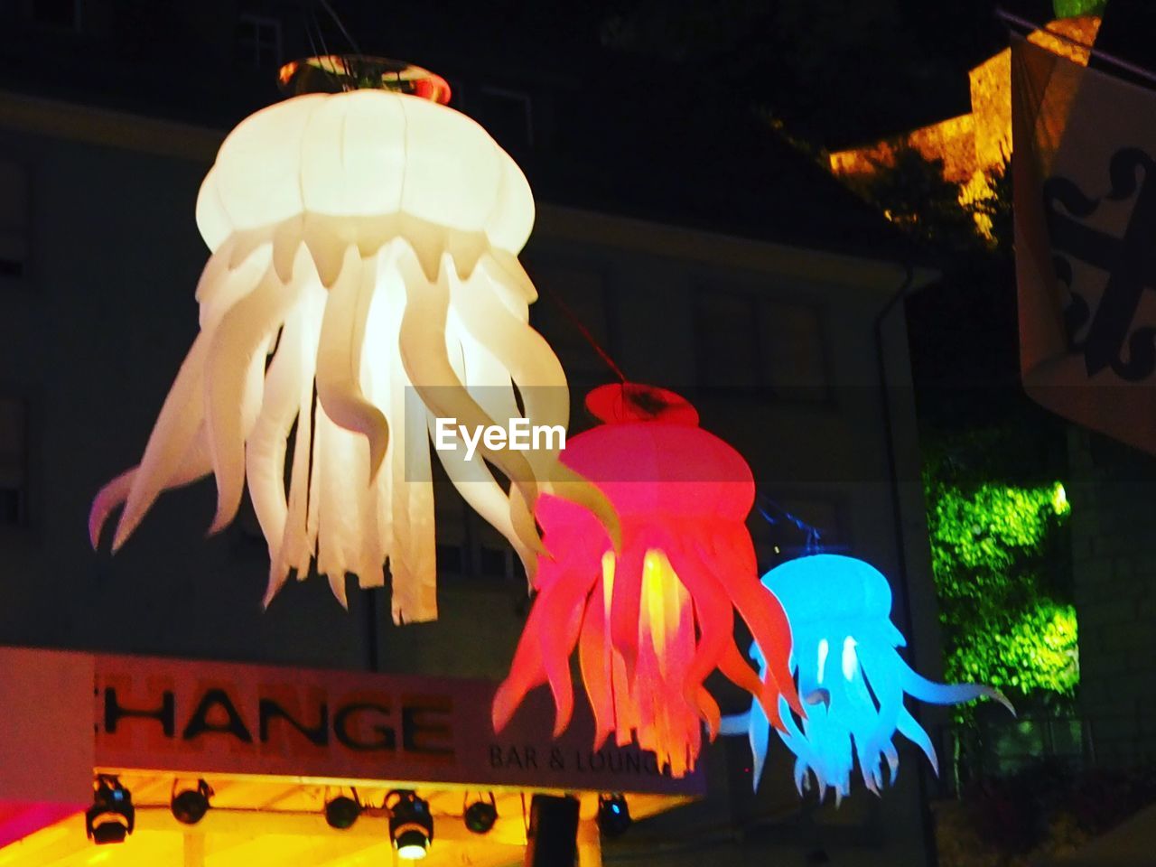 LOW ANGLE VIEW OF ILLUMINATED LANTERNS ON STREET