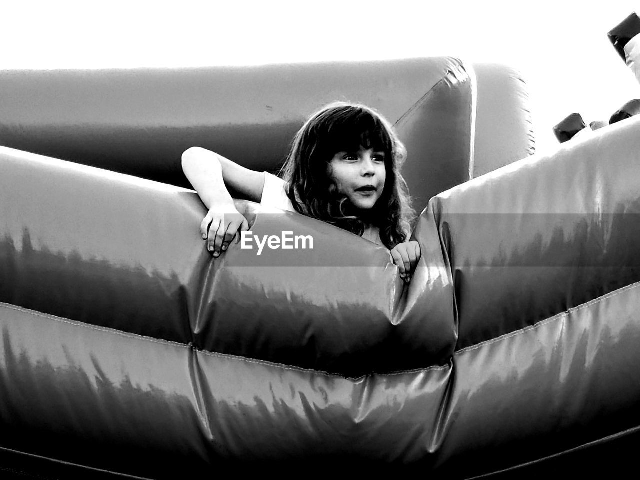 Low angle view of girl on bouncing castle