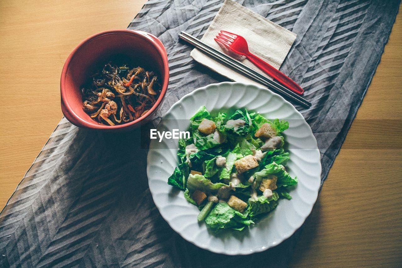 High angle view of salad with soup served on table