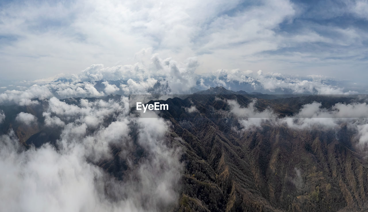 aerial view of snowcapped mountains against sky