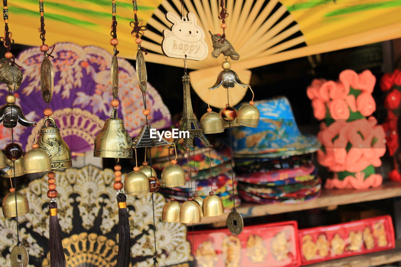 Close-up of decorations hanging in store for sale