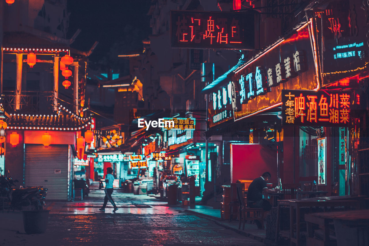 Illuminated city street at night