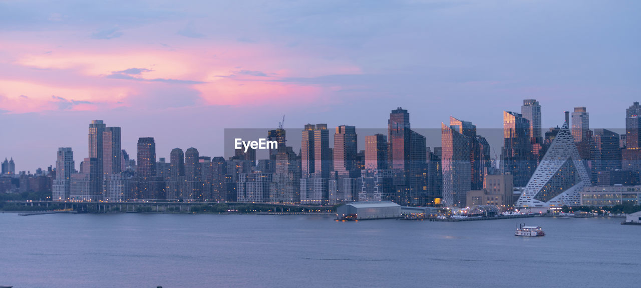 VIEW OF CITY BUILDINGS AGAINST SKY DURING SUNSET