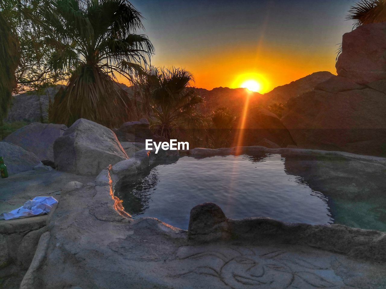 SCENIC VIEW OF ROCKS AGAINST ORANGE SKY