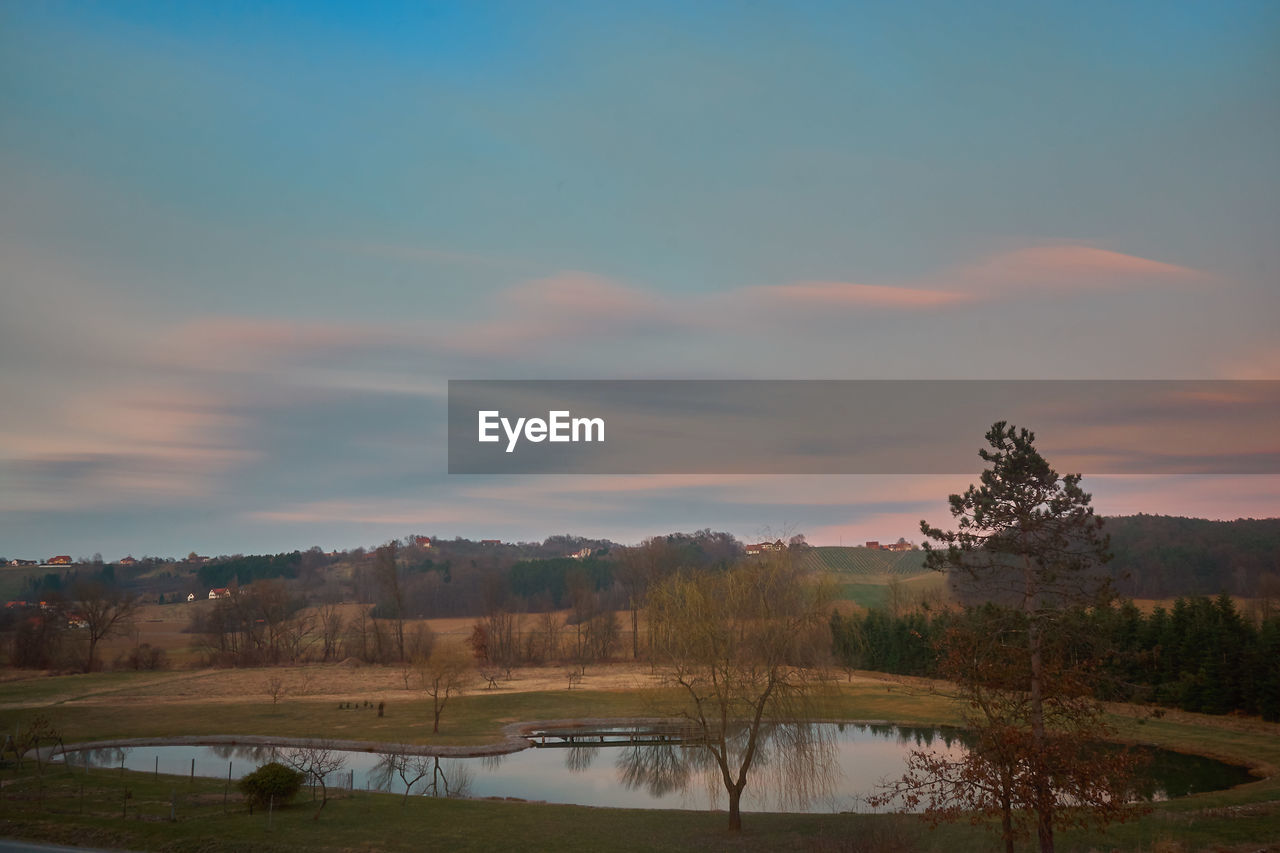 Scenic view of lake against sky during sunset