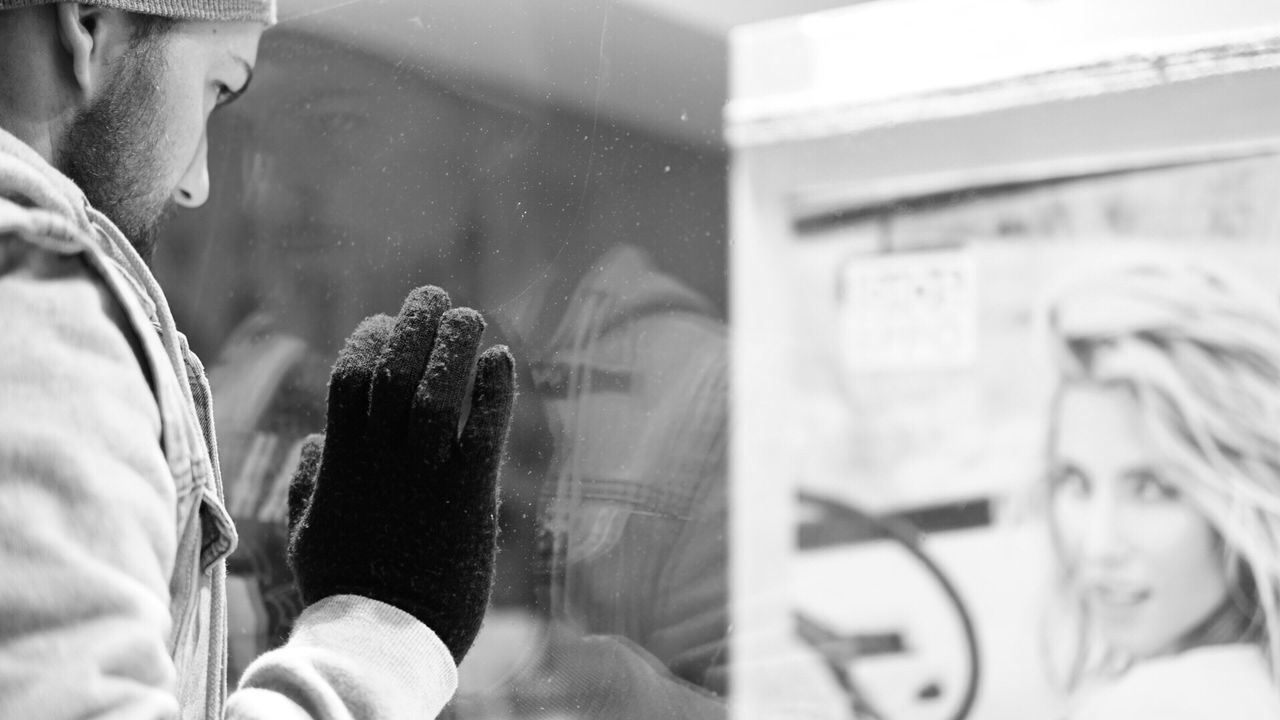 REFLECTION OF PEOPLE IN WINDOW