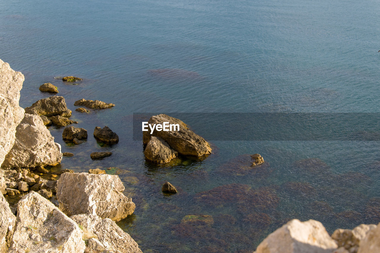 High angle view of rocks in sea