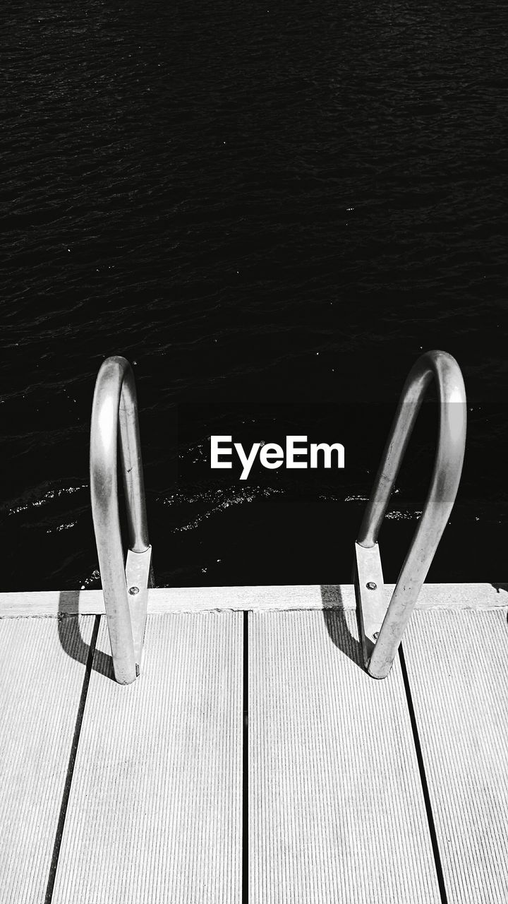 High angle view of railing on pier over sea