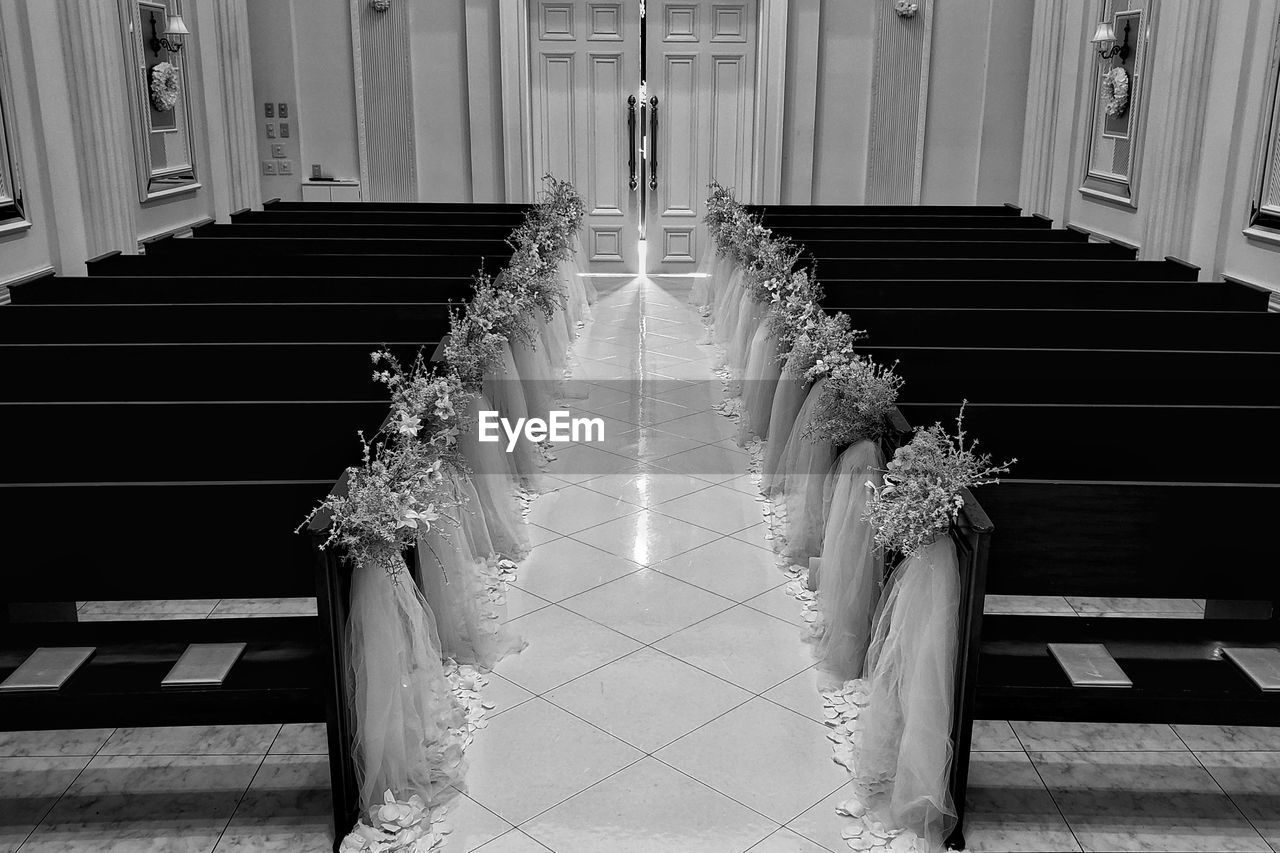 Inside of christian chapel with cross reflected in light