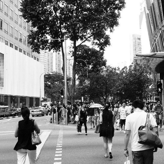 PEOPLE WALKING ON STREET IN CITY