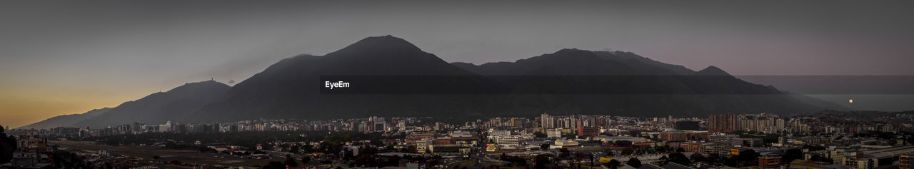 Panoramic view of cityscape against sky at night