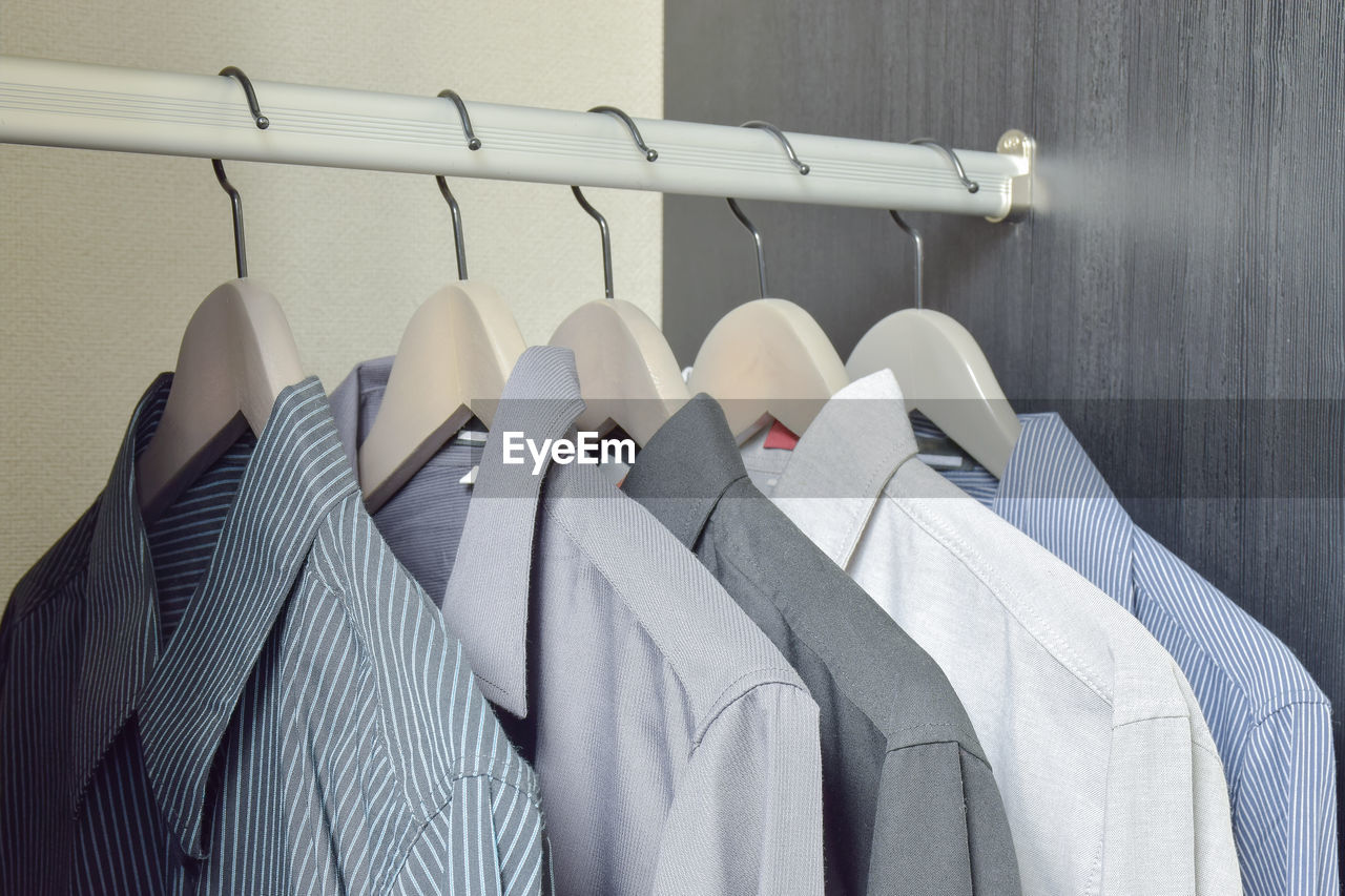 Close-up of shirts hanging on rack at home