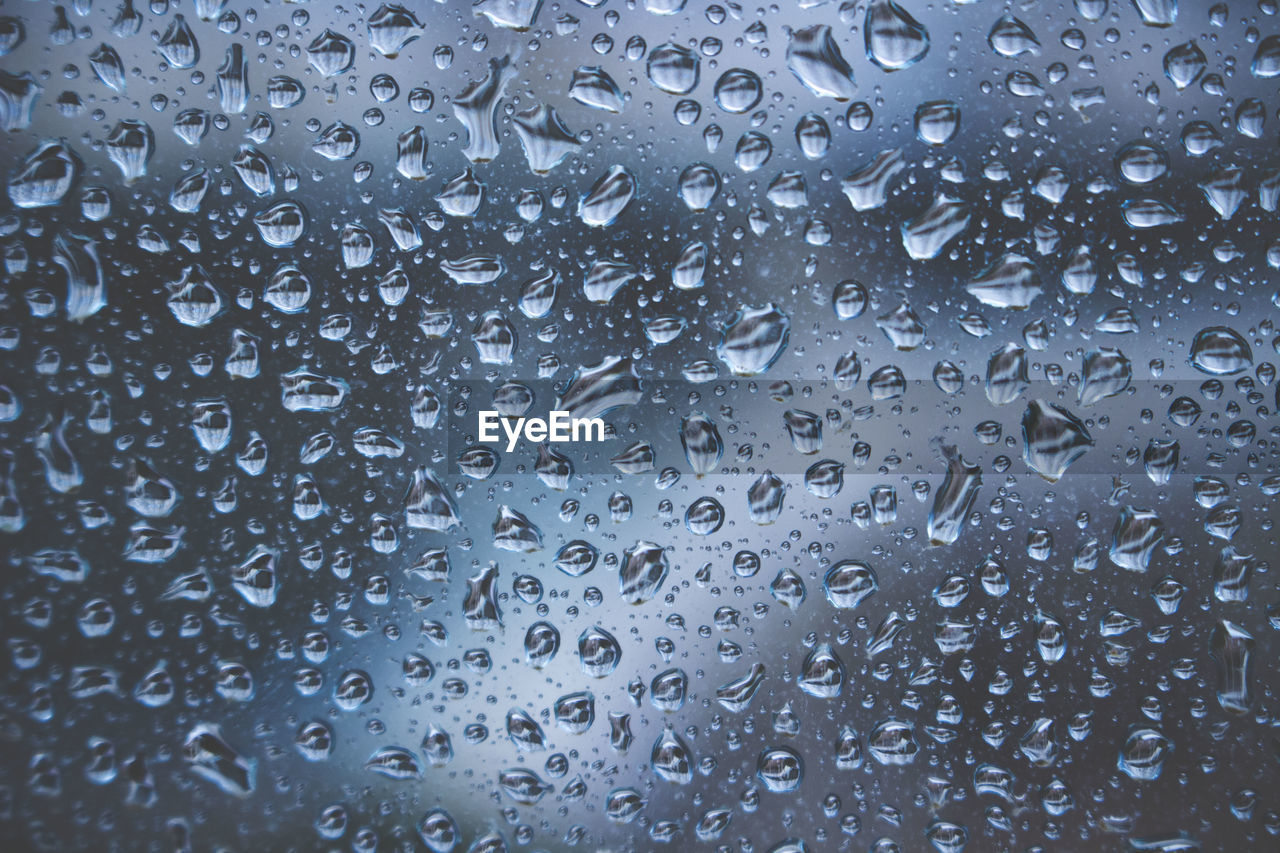 Full frame shot of raindrops on window