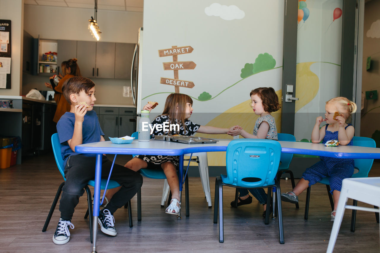 Children sit for lunchtime at an educational facility