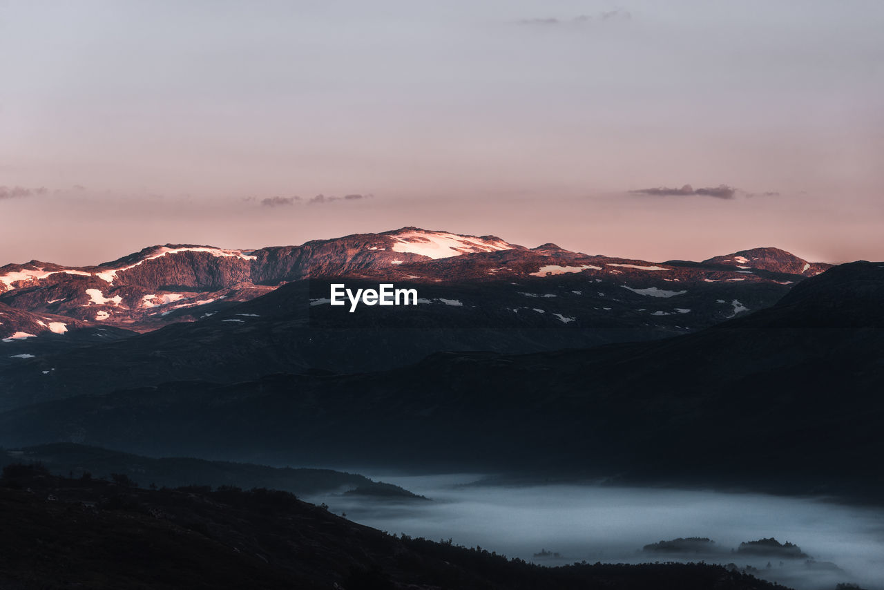 SCENIC VIEW OF MOUNTAINS AGAINST SKY DURING SUNSET