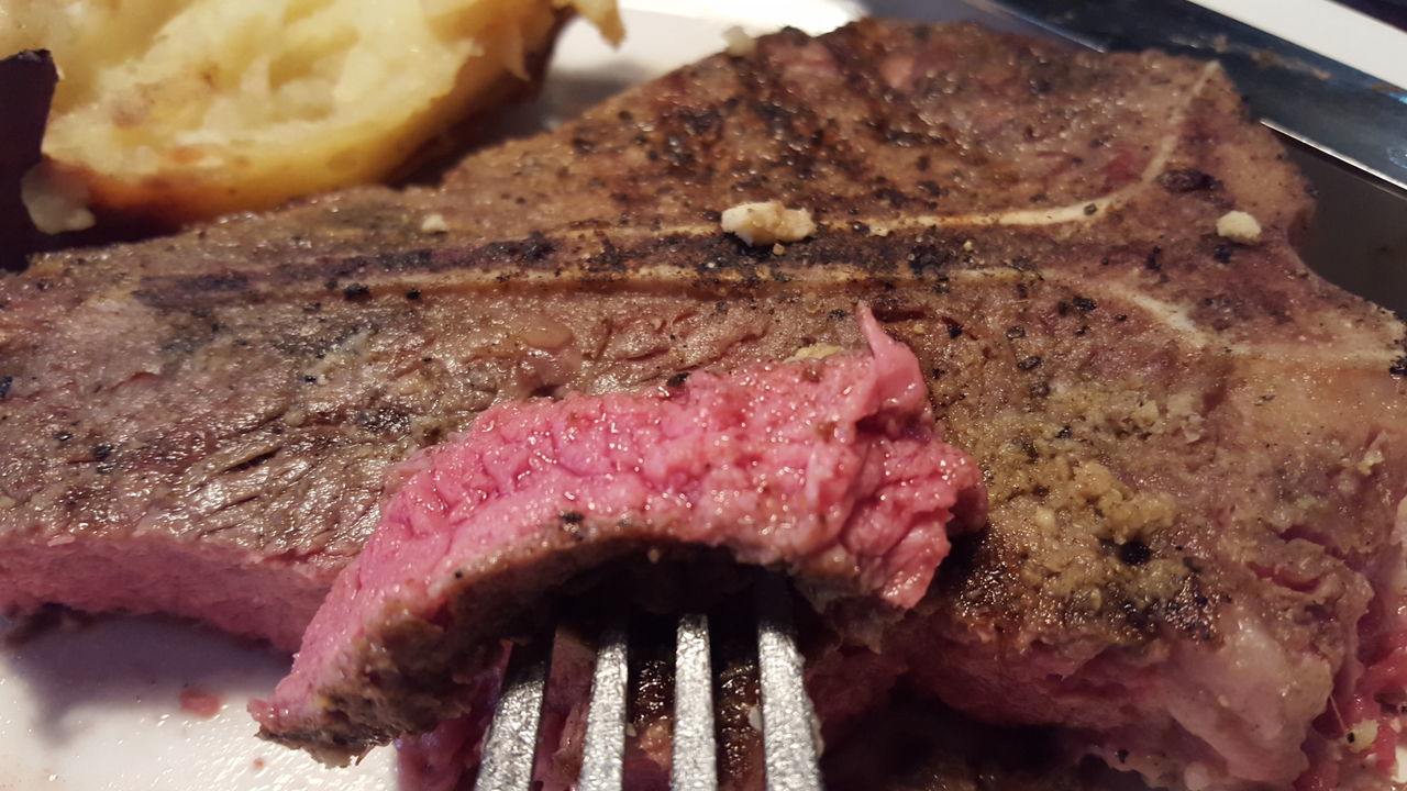 CLOSE-UP OF MEAT ON TABLE