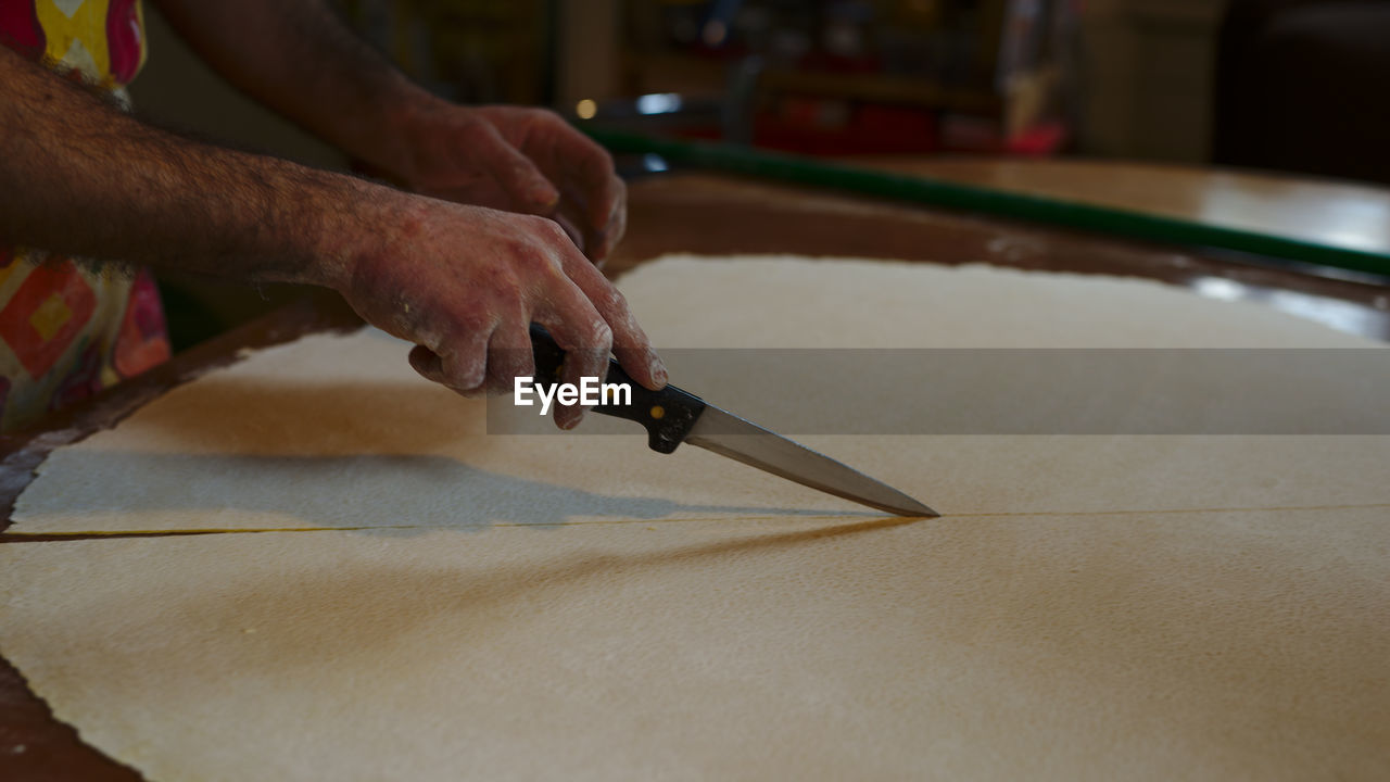 Cropped image of man preparing food on table