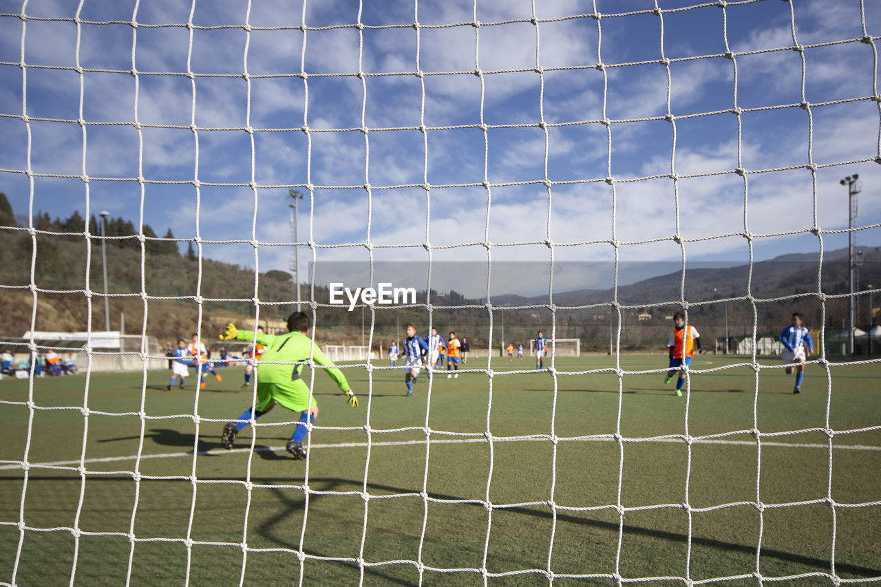 Men playing soccer on field