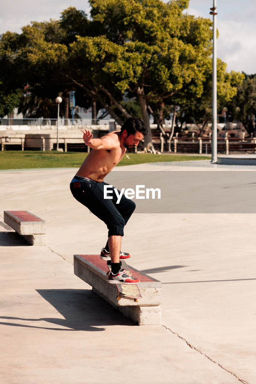 Boy doing skateboard trick on rail