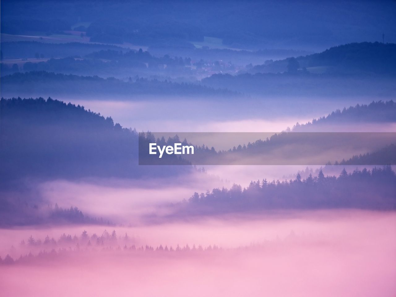 Pink daybreak in hilly landscape. autumn misty morning in a beautiful rocky hills. peaks of hills 