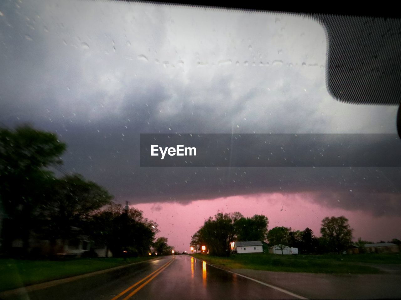 Street seen through wet car window