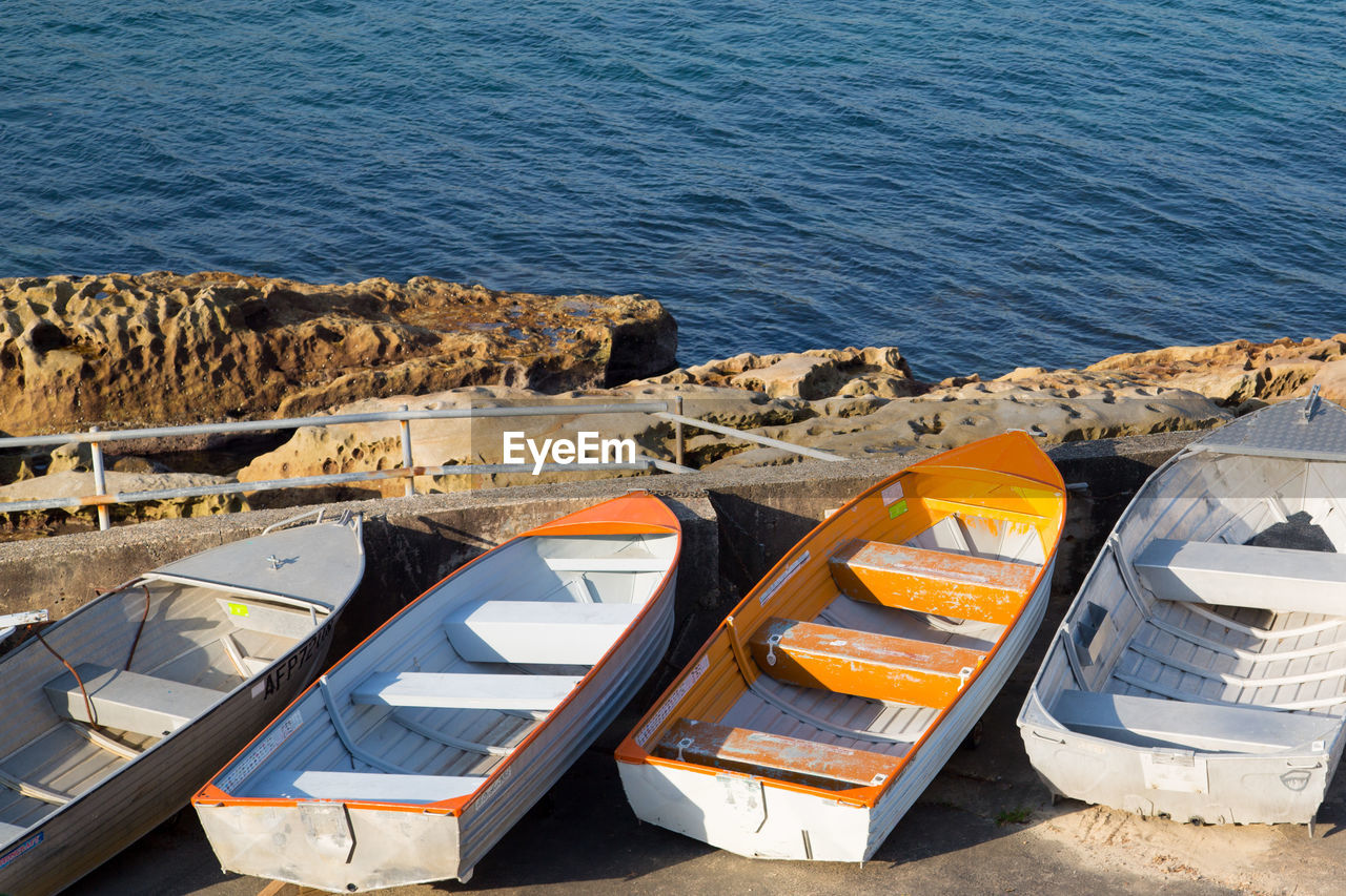 High angle view of boats moored on pier by sea