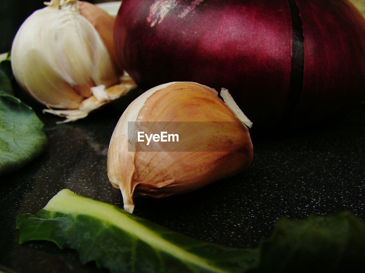 Close-up of garlic by onion on table