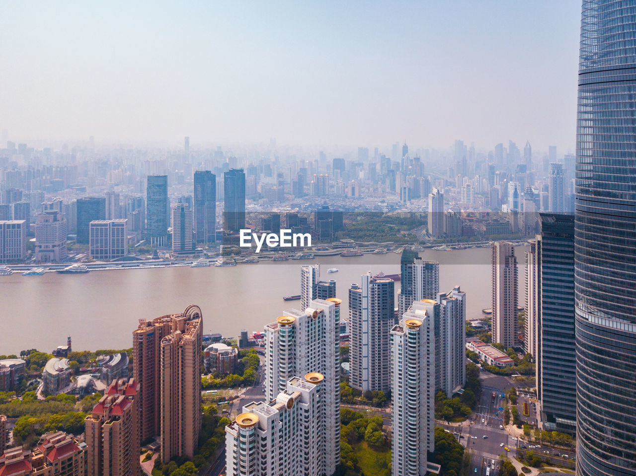 Aerial view of buildings in city against sky