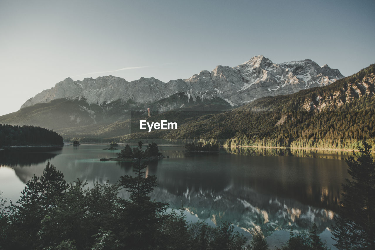 Scenic view of lake and mountains against clear sky