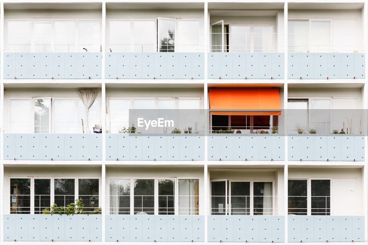 Low angle view of retro residential building with balconies 