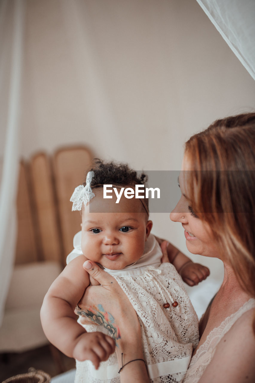 PORTRAIT OF MOTHER AND BABY WITH DAUGHTER