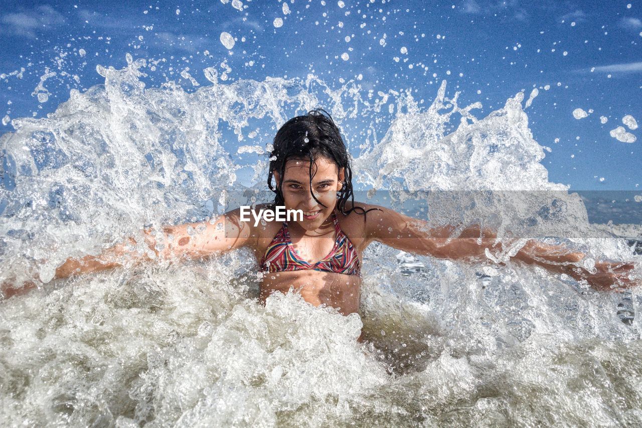 Portrait of smiling girl swimming in sea