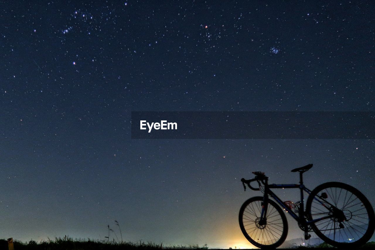 BICYCLE AGAINST CLEAR SKY AT NIGHT