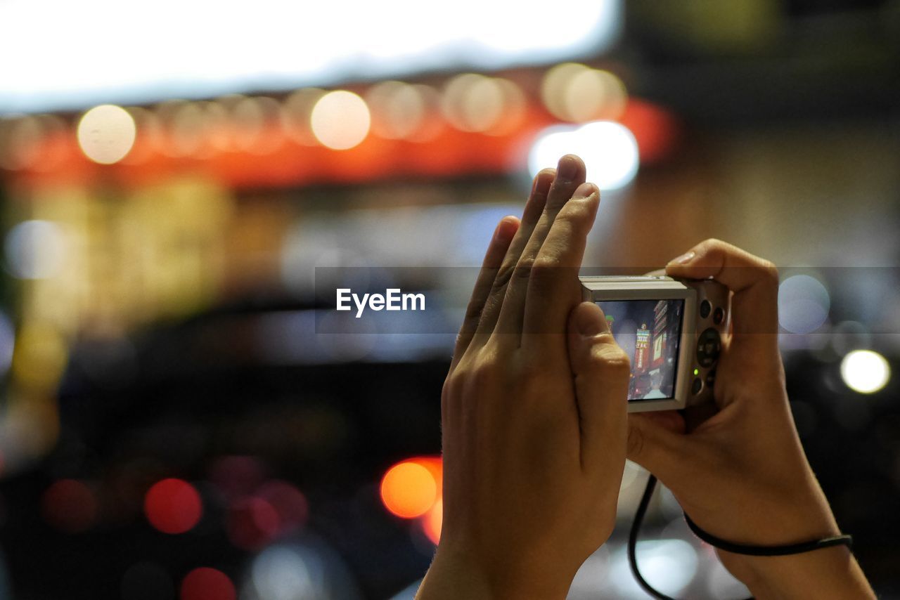 Close-up of hand photographing with camera