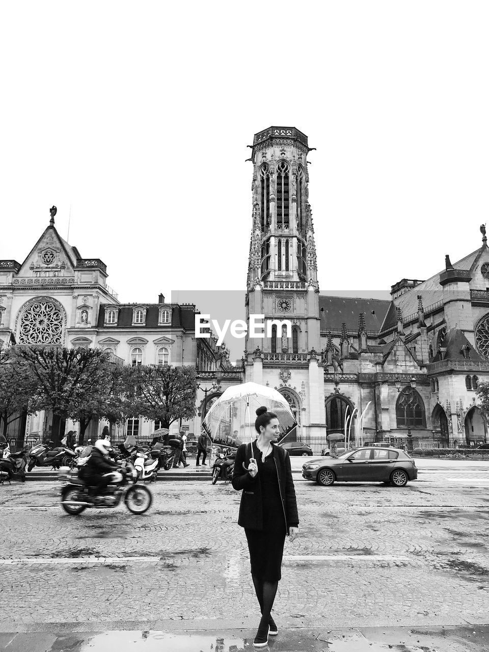 Full length of woman with umbrella while standing in city