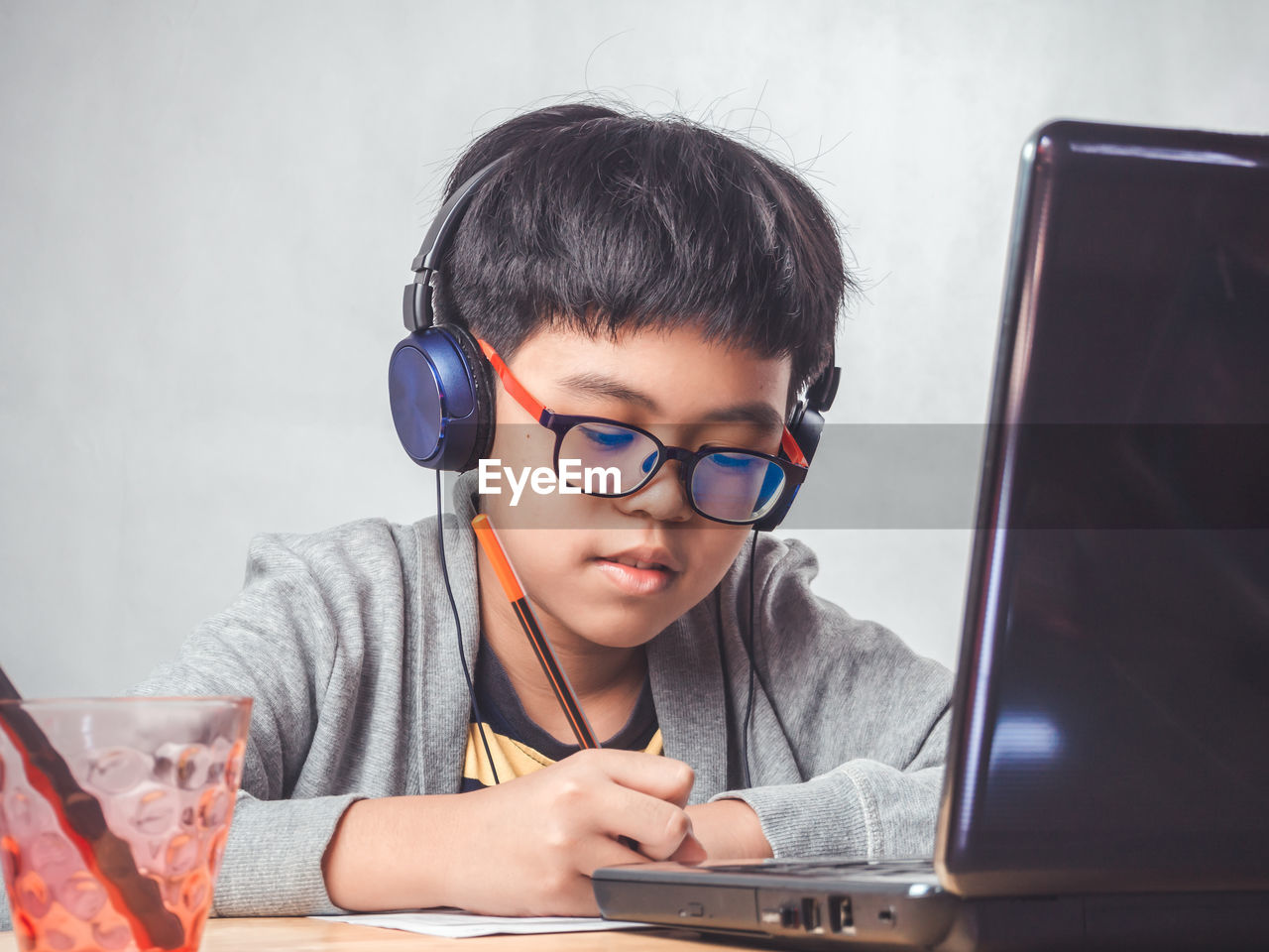 PORTRAIT OF BOY SITTING ON TABLE AT HOME